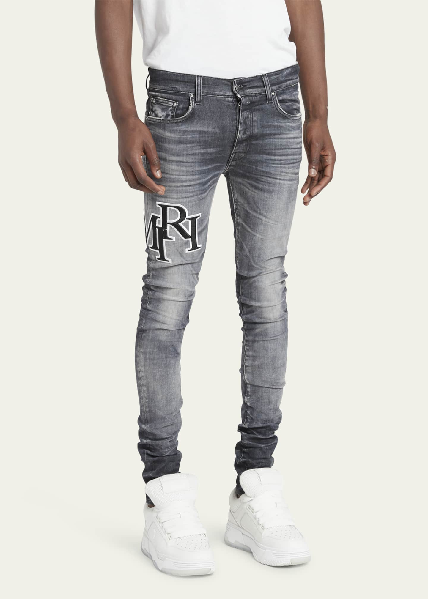 Amiri Men's Faded Skinny Jeans with Staggered Logo