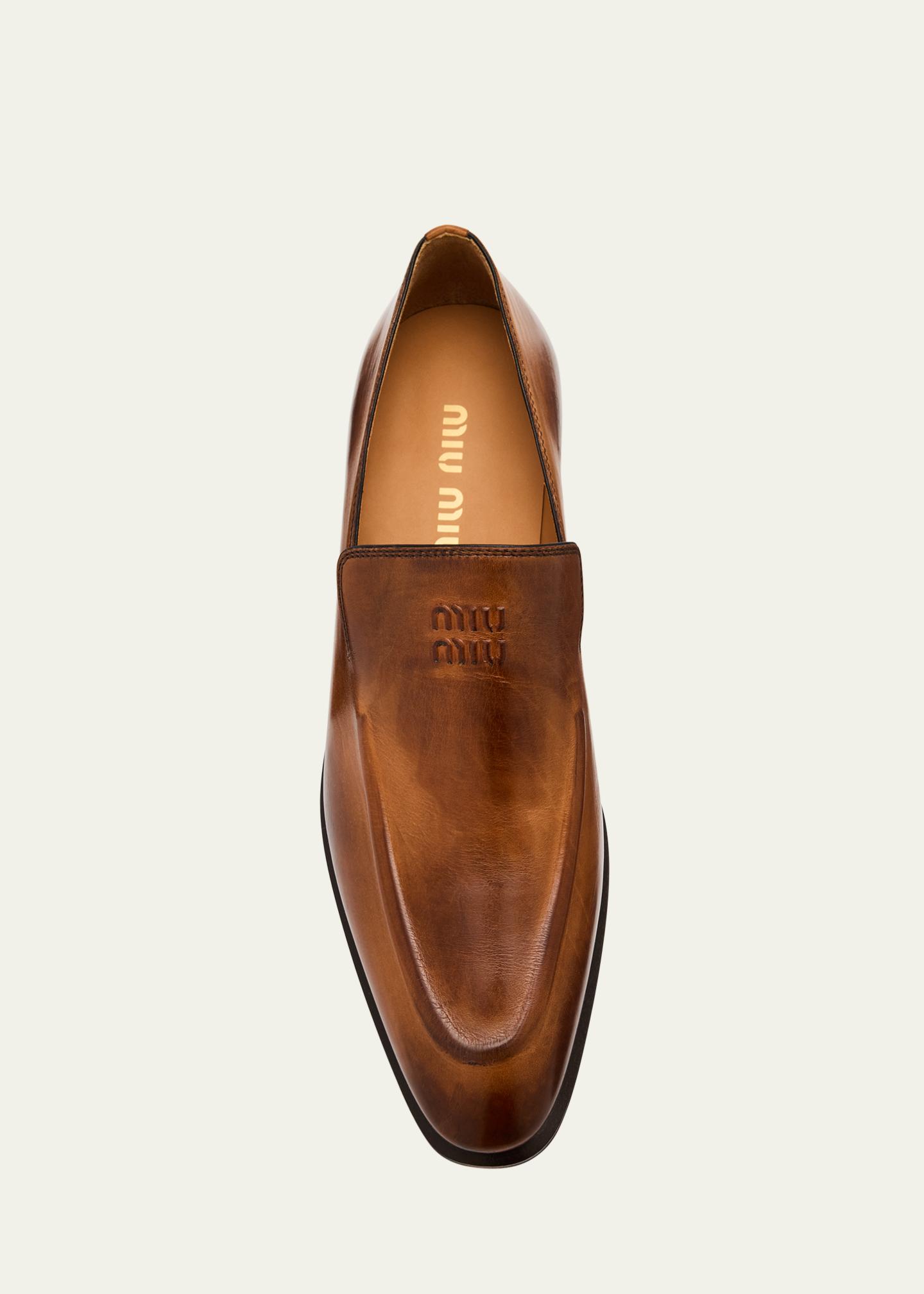 Miu Miu Embossed Logo Leather Mocassin Loafers - Bergdorf  display picture 3